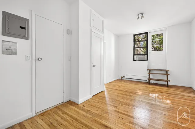a view of room with window and wooden floor