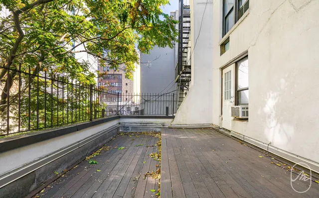 a view of balcony with wooden floor