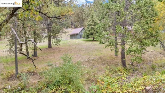 a kitchen with granite countertop a sink window and cabinets