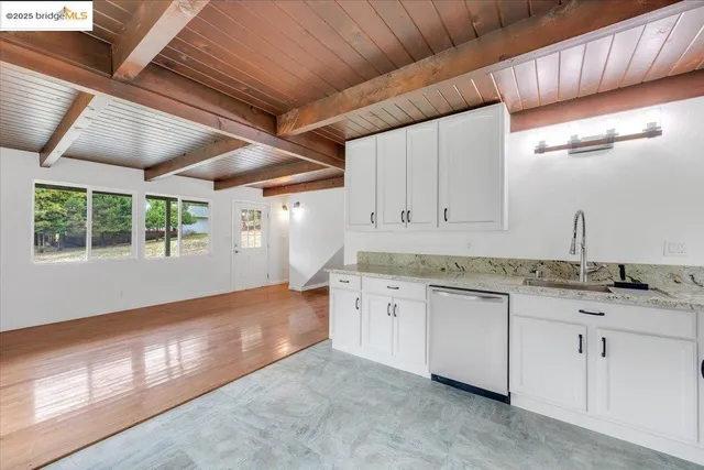 a kitchen with stainless steel appliances granite countertop a stove and a sink