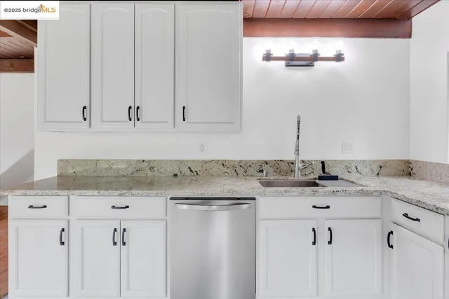 a view of a kitchen with microwave and cabinets