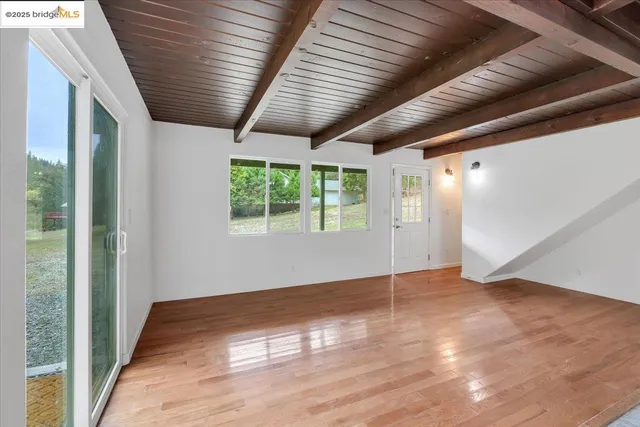 a view of a kitchen with wooden floor and a window