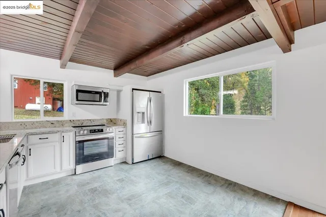 a view of empty room with wooden floor and outer view