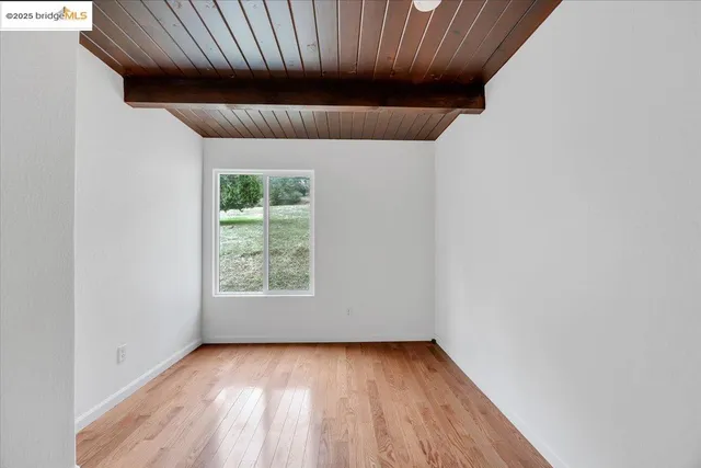 a bedroom with bed and a window