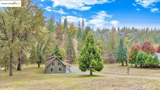 a front view of a house with yard and garage