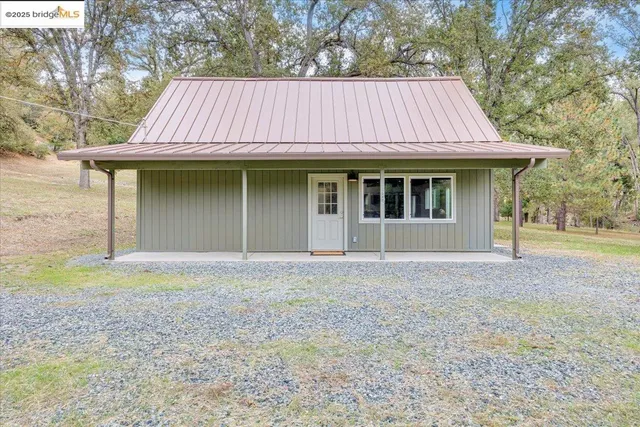 an aerial view of a house with a yard