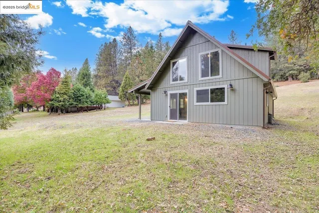a view of a house with a yard and garage