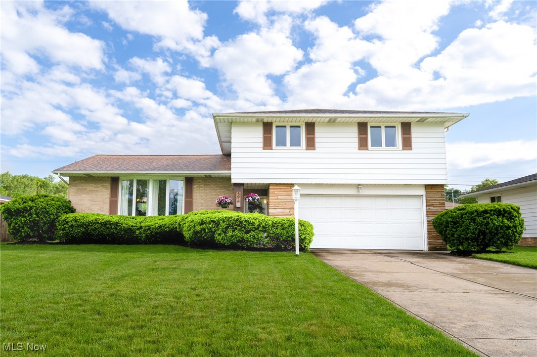 594 Long Ridge Drive Independence, OH 44131 - Photo 1 of 36 Split level home featuring a garage, driveway, brick siding, and a front yard