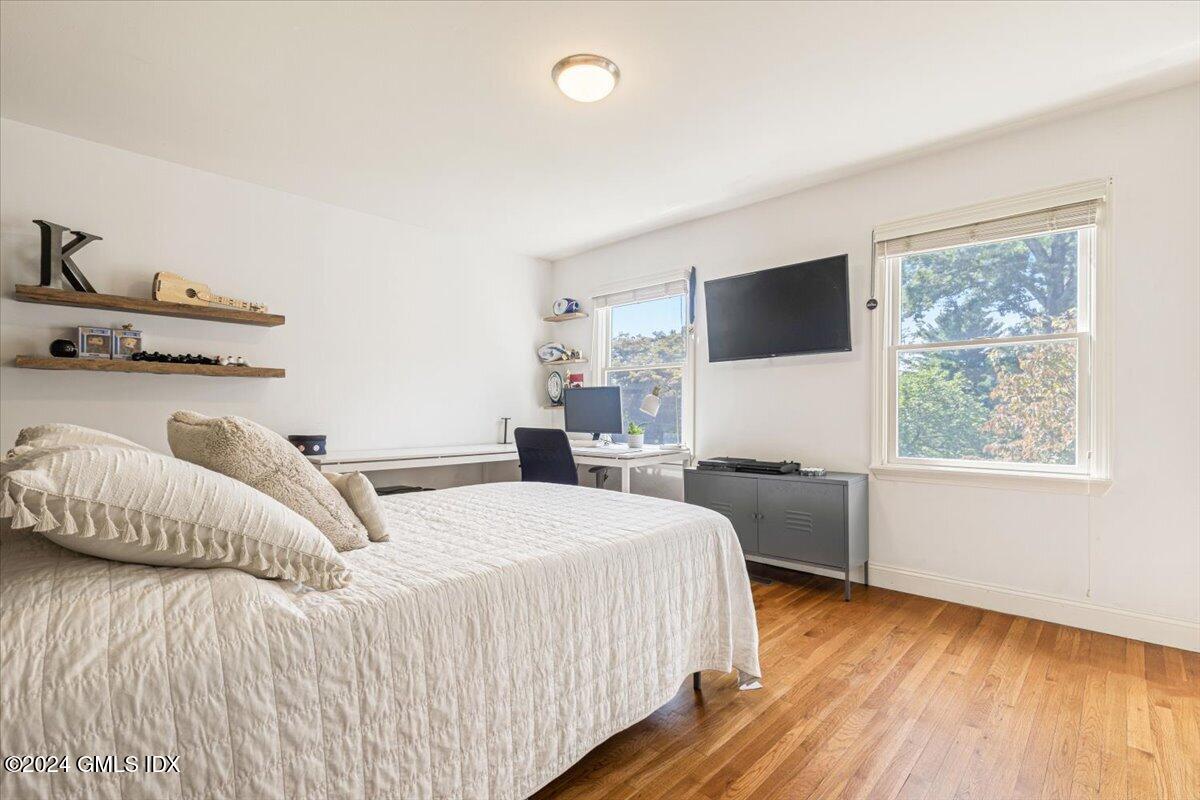 70 Gregory Road Cos Cob, CT 06807 - Photo 17 of 39 a bedroom with a bed and a flat screen tv