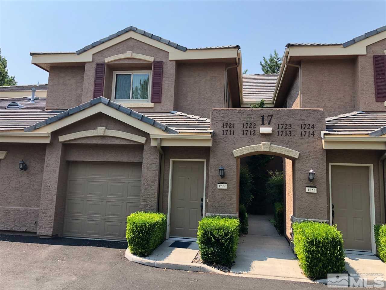 900 South Meadows Parkway, Unit 1712 Reno, NV 89521 - Photo 1 of 13 a view of a house with a garage and a yard