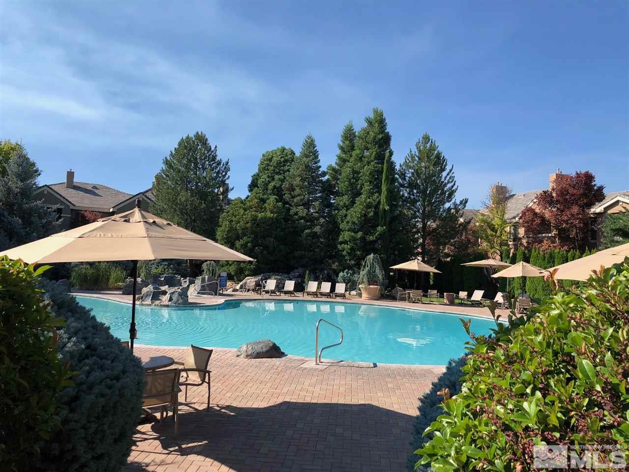 900 South Meadows Parkway, Unit 1712 Reno, NV 89521 - Photo 12 of 13 a view of a garden with chairs and an umbrella