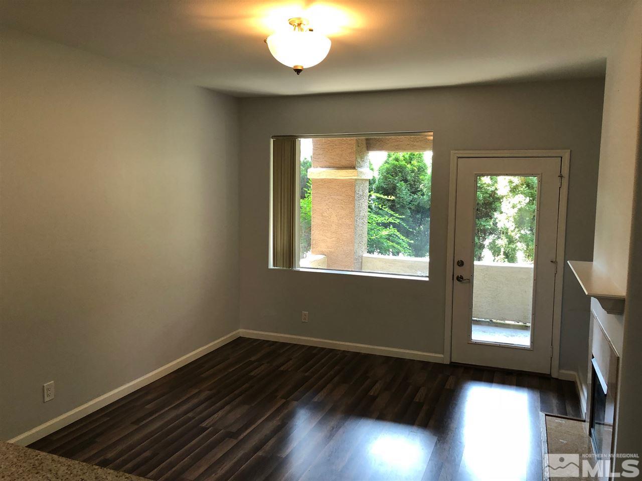 900 South Meadows Parkway, Unit 1712 Reno, NV 89521 - Photo 3 of 13 a view of an empty room with wooden floor and a window