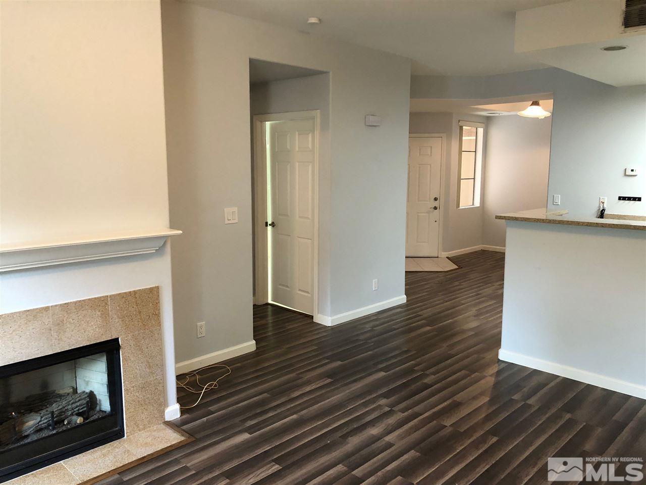 900 South Meadows Parkway, Unit 1712 Reno, NV 89521 - Photo 4 of 13 a view of an empty room with wooden floor and a fire place