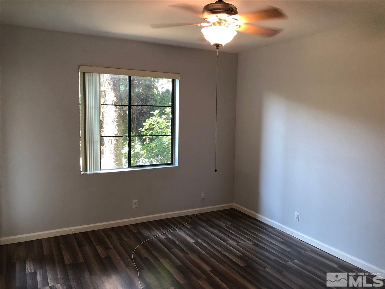 900 South Meadows Parkway, Unit 1712 Reno, NV 89521 - Photo 7 of 13 a view of an empty room with wooden floor and a window