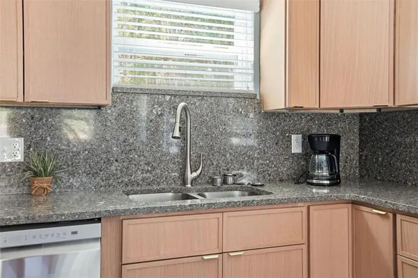 a kitchen with stainless steel appliances granite countertop a refrigerator stove and microwave
