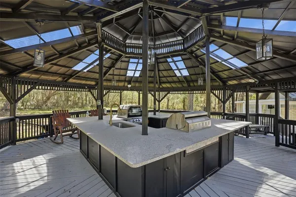 a view of a pathway with a white house with a small yard and wooden fence