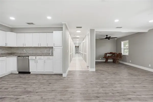 an empty room with a window and a ceiling fan