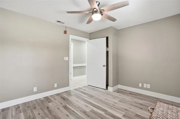 an aerial view of residential houses with outdoor space and trees