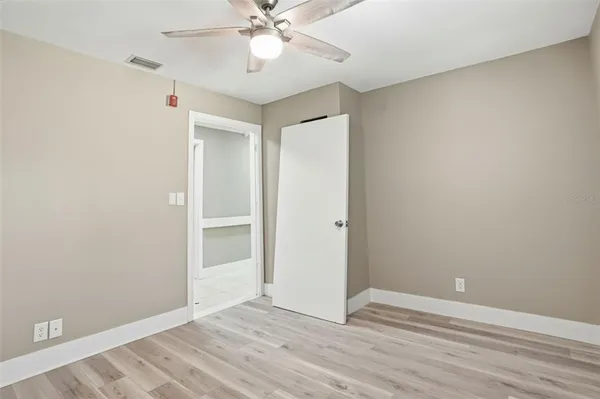 a view of a house with a yard and large tree