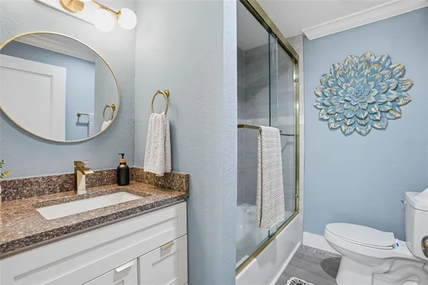 a kitchen with sink refrigerator and cabinets