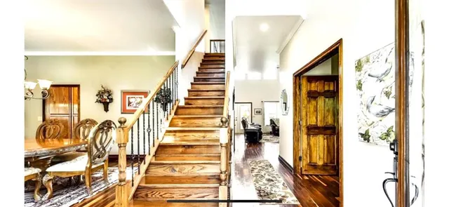 a view of a hallway with wooden floor and staircase