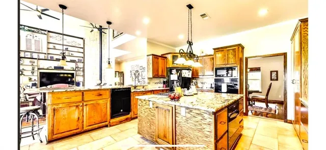 a view of a kitchen with living room and wooden floor
