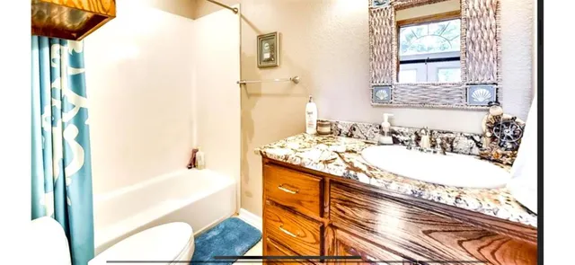 a view of a patio with table and chairs and potted plants