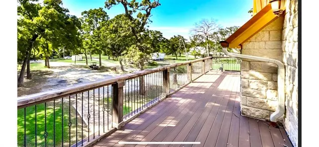 a view of balcony with wooden floor and fence