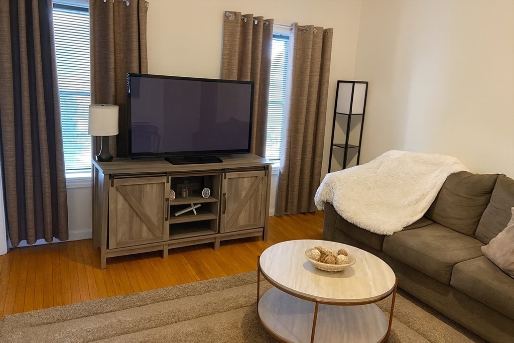256 Union Street, Unit 3 Fall River, MA 02721 - Photo 2 of 4 a living room with furniture and a flat screen tv