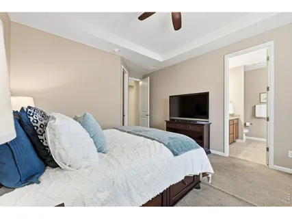 a bedroom with a large bed and a television