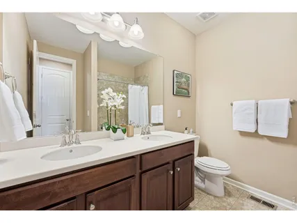 a bathroom with a sink a toilet and a mirror