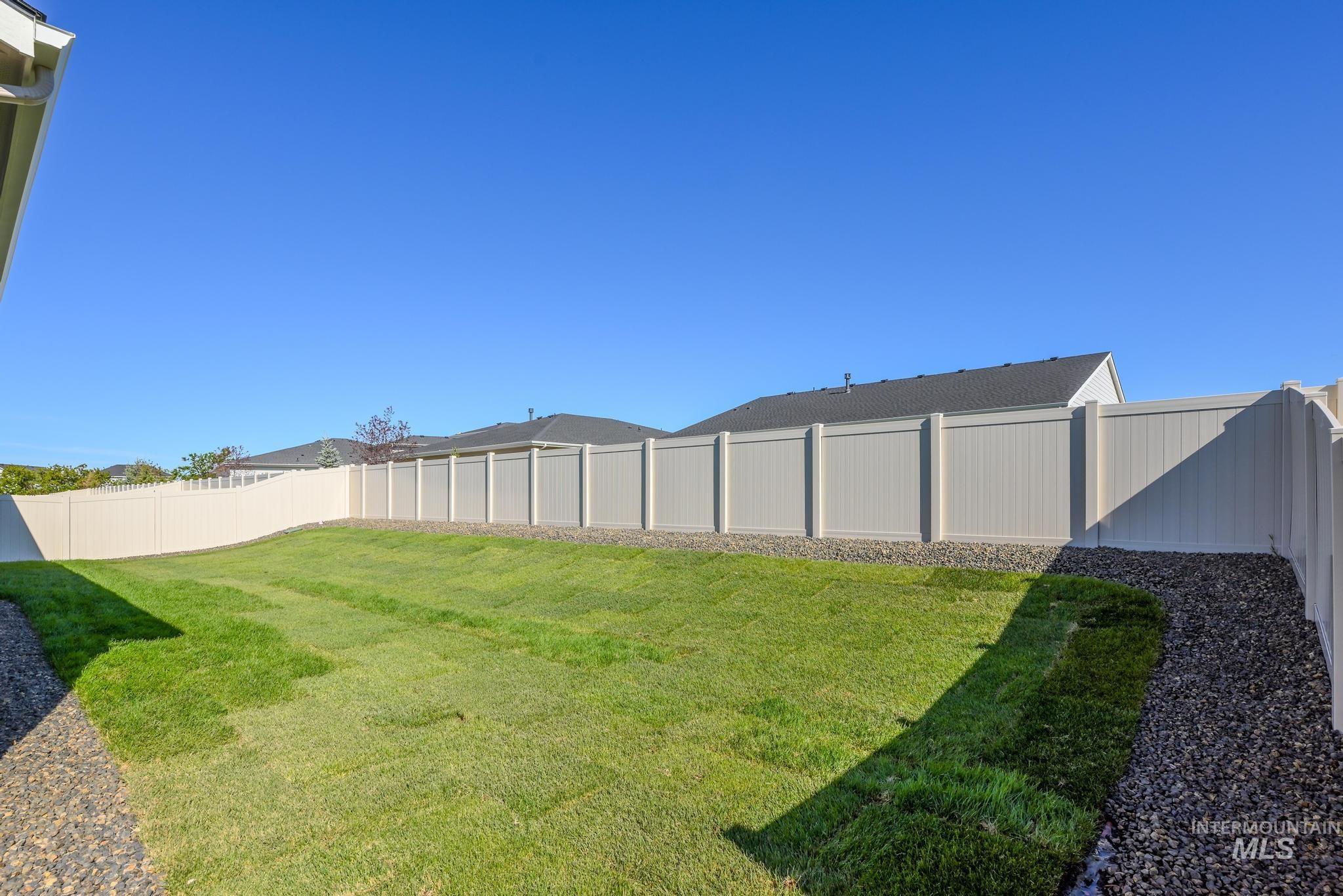 9074 West Moonglade Street Star, ID 83669 - Photo 31 of 40 Expansive backyard featuring a new lawn, gravel borders, and full perimeter fencing