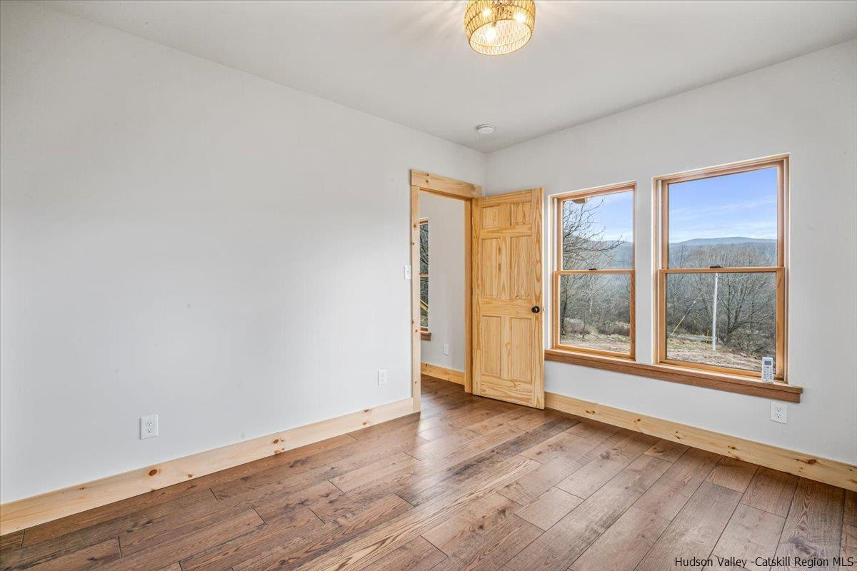 41 Carr George Road Roxbury, NY 12421 - Photo 16 of 26 a view of an empty room with wooden floor and a window