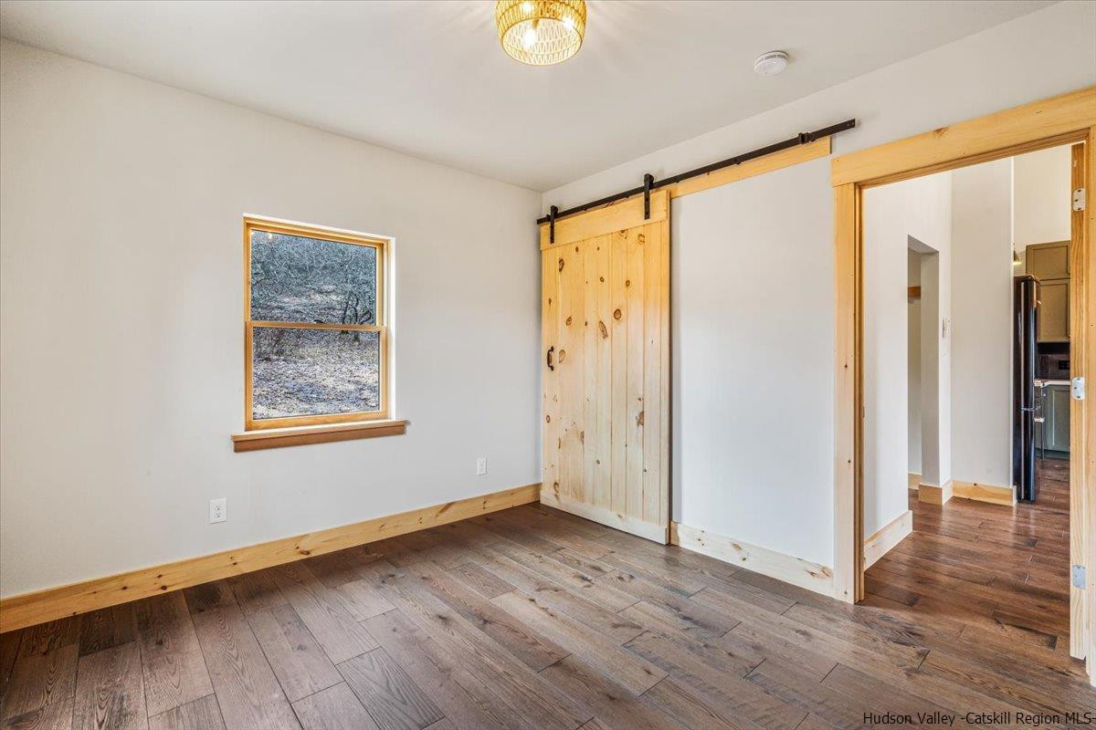 41 Carr George Road Roxbury, NY 12421 - Photo 22 of 26 a view of an empty room with wooden floor and a window