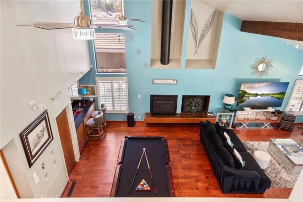 a living room with fireplace furniture and a wooden floor