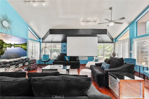 a kitchen with stainless steel appliances granite countertop a stove top oven a sink dishwasher a dining table and chairs with wooden floor