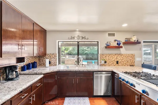 a kitchen with a refrigerator and a stove