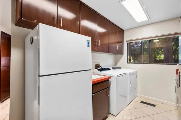 a bedroom with a bed a table and wooden floor