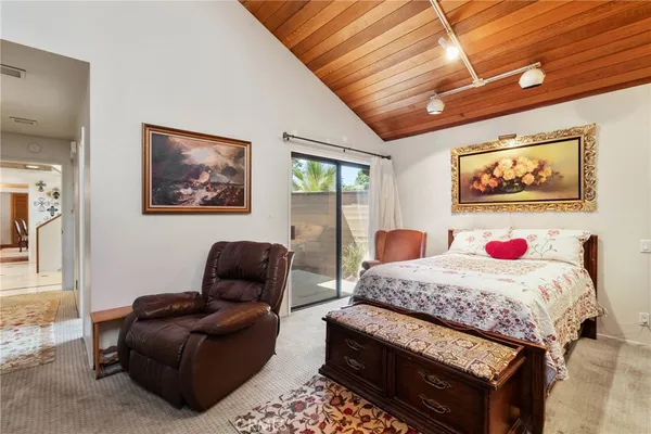 a bedroom with furniture and a wooden floor
