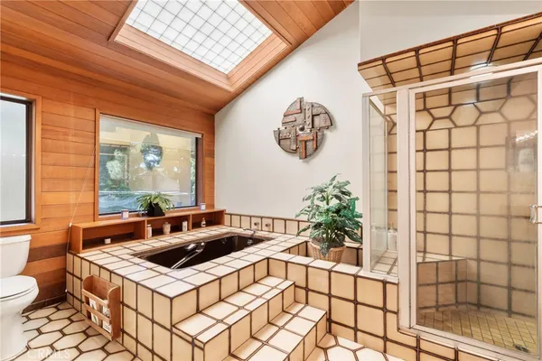 a bathroom with a granite countertop shower and a sink