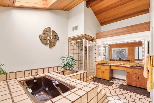 a living room with furniture a flat screen tv and a table