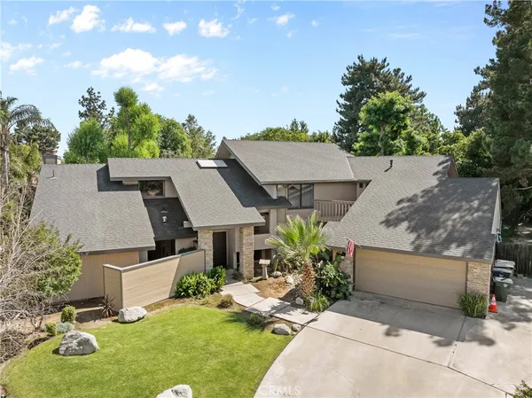an aerial view of a house with garden space and street view