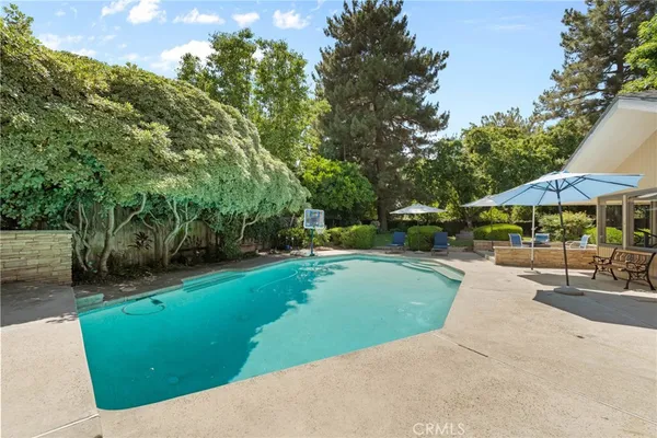 an aerial view of a house with a yard and garden