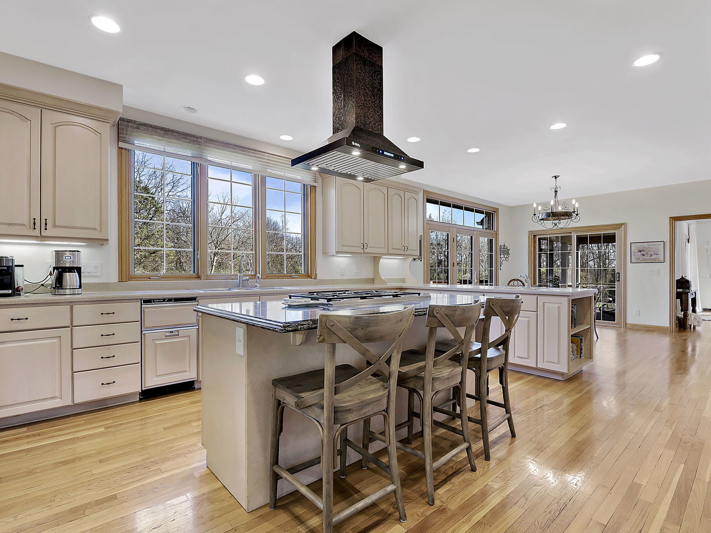 4N891 Old Farm Road St. Charles, IL 60175 - Photo 10 of 27 a kitchen with stainless steel appliances granite countertop a stove a sink dishwasher a dining table and chairs with wooden floor