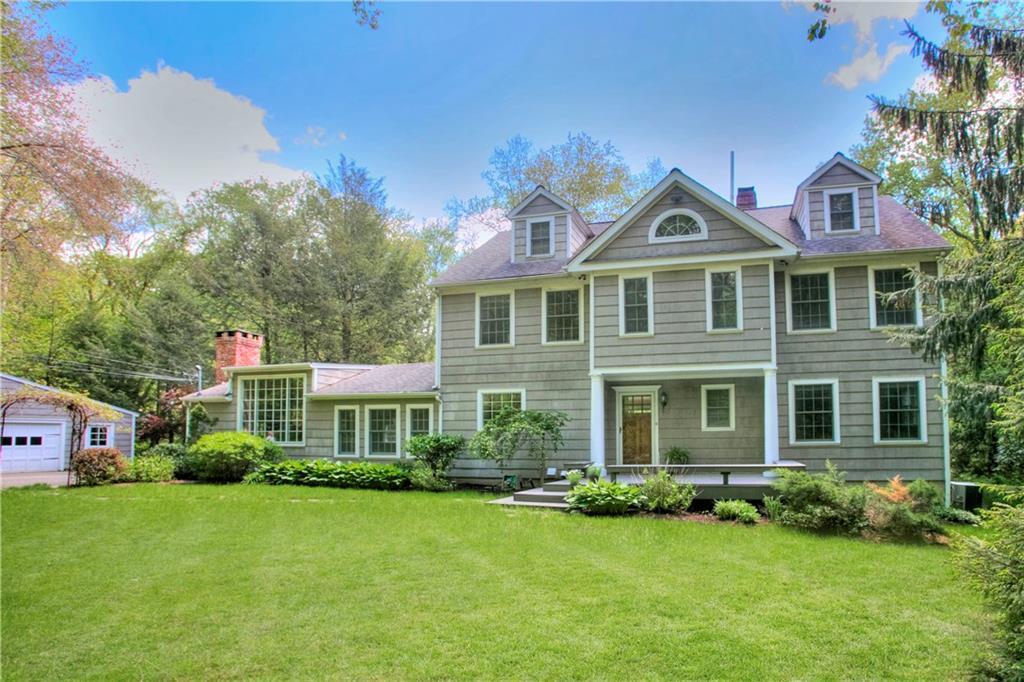 2 Spring Valley Road Weston, CT 06883 - Photo 1 of 1 a front view of a house with a garden