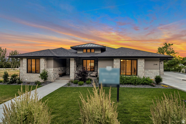 2145 North Main Street Centerville, UT 84014 - Photo 5 of 53 Prairie-style home featuring stone siding, a lawn, a shingled roof, and a standing seam roof
