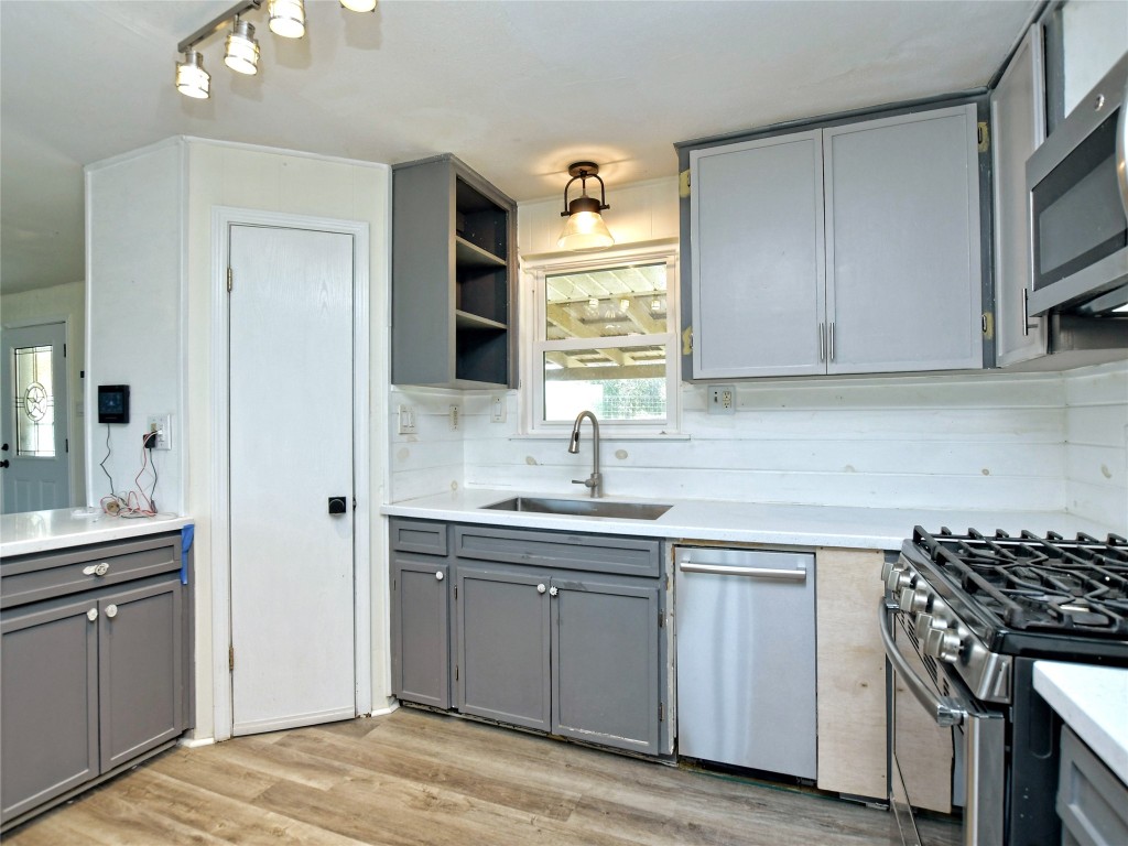 1000 County Road 484 Elgin, TX 78621 - Photo 11 of 30 a kitchen with cabinets appliances a sink and a counter top space