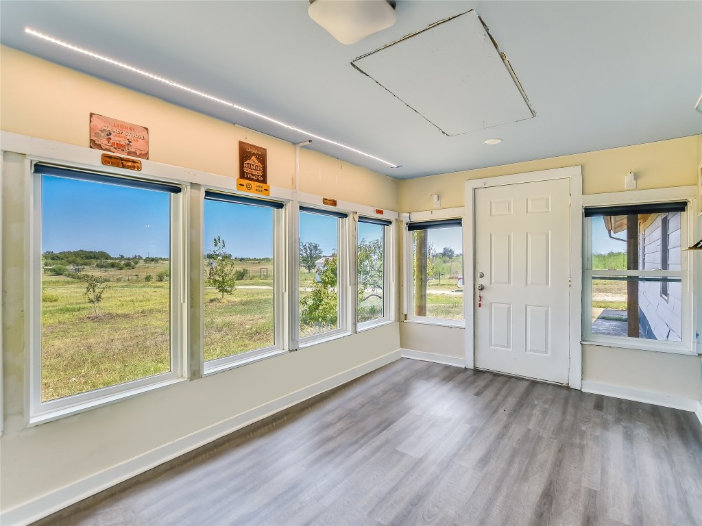 1000 County Road 484 Elgin, TX 78621 - Photo 14 of 30 a view of an empty room with wooden floor and a window