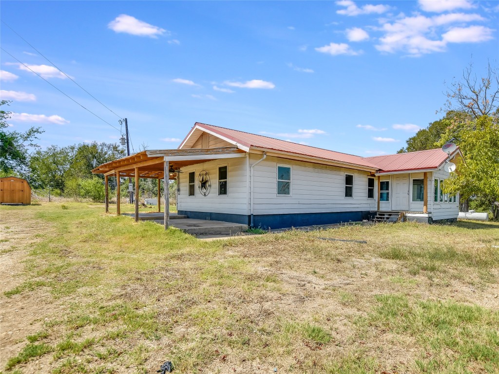 1000 County Road 484 Elgin, TX 78621 - Photo 2 of 30 a front view of a house with a garden