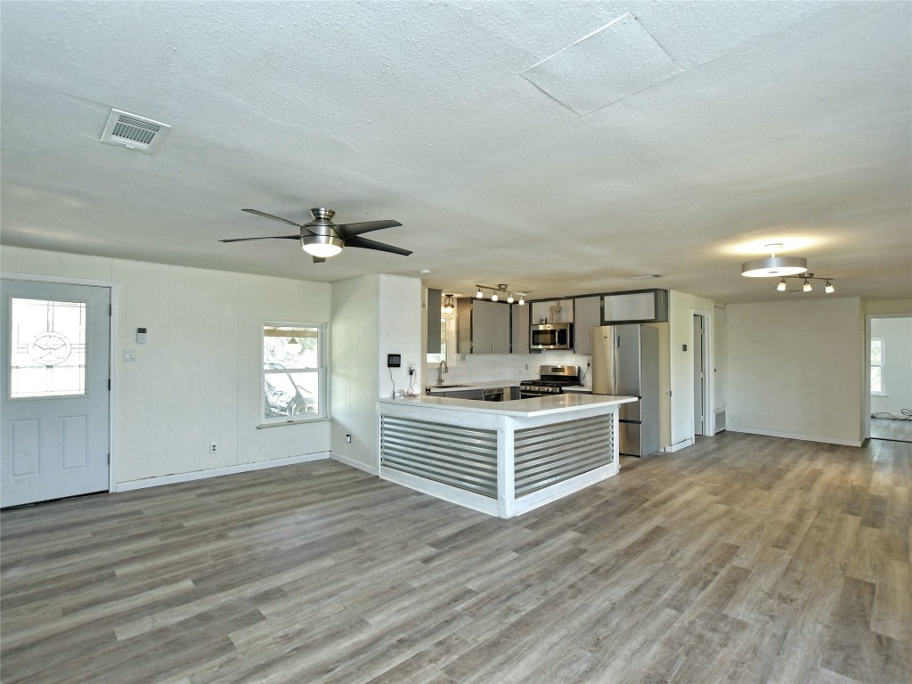 1000 County Road 484 Elgin, TX 78621 - Photo 8 of 30 a view of kitchen with sink cabinet and a fireplace